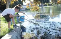  ?? BEA AHBECK/NEWS-SENTINEL FILE PHOTOGRAPH ?? Dane Marshall, 8, and his mother, Pamela Marshall, both of Lodi, fish for trash during last year’s Coastal Cleanup at Lodi Lake.