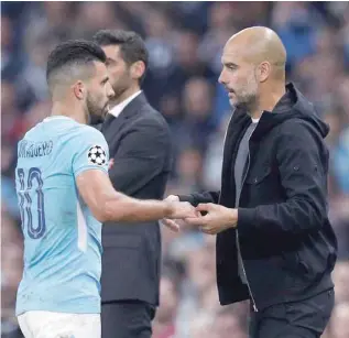  ?? — Reuters ?? Manchester City’s Sergio Aguero with manager Pep Guardiola as he is substitute­d.