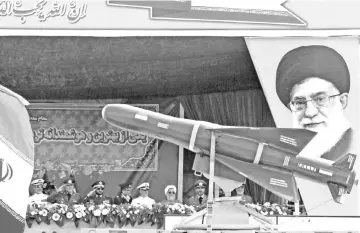  ?? — AFP photo ?? An Iranian military truck carries missiles past a portrait of Iran’s Supreme Leader Ayatollah Ali Khamenei during a parade on the occasion of the country’s annual army day in Tehran.