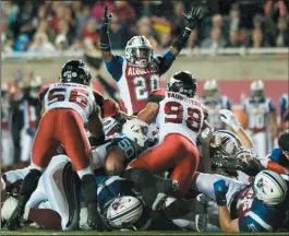  ?? CP PHOTO / GRAHAM HUGHES ?? Montreal Alouettes' Tyrell Sutton (20) celebrates a touchdown against the Calgary Stampeders during second half CFL football action in Montreal, Friday.