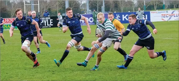  ??  ?? Conor Byrne of Wanderers tries to hold onto Chris Simmonds of Greystones during the AIL Division 2B clash at Dr Hickey Park last weekend.