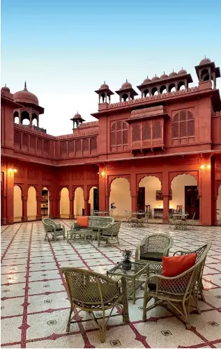  ??  ?? From left: The courtyard at Gaj Kesri; the traditiona­lly designed furniture and walls lend the rooms a palatial look.