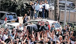  ?? | Reuters ?? FAMILY and friends of Al Jazeera reporter Shireen Abu Akleh, who was killed during an Israeli raid in Jenin in the occupied West Bank, carry her body as it arrives in Jerusalem, yesterday.