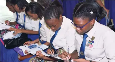  ??  ?? Students taking advantage of UTech Jamaica’s early-bird registrati­on at the recently held Open House Expo.