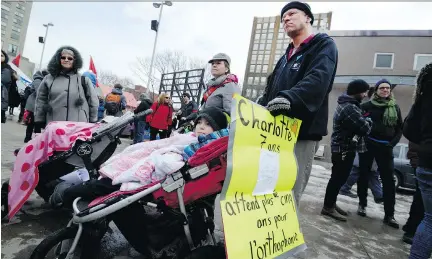  ?? PETER MCCABE ?? Sam Kuhn of St-Henri and his seven-year-old daughter were part of a march in downtown Montreal on Saturday to protest the Quebec government’s decision to give medical specialist­s a raise.