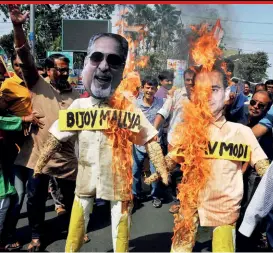  ??  ?? Congress activists burn effigies of Vijay Mallya, Nirav Modi and Lalit Modi in Kolkata