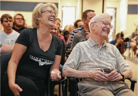  ?? Yi-Chin Lee photos / Houston Chronicle ?? Kathy Walker and her father, U.S. Army Air Corps World War II veteran William Fly, celebrate Fly’s 100th birthday at Cypress Creek Education Center. Fly lost his wife three months before Hurricane Harvey flooded his home and made it unlivable.