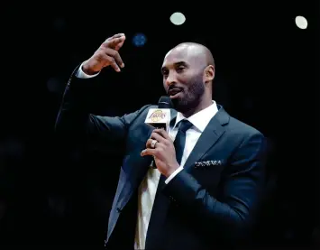  ?? ASSOCIATED PRESS ?? FORMER LOS ANGELES LAKER KOBE BRYANT speaks during a halftime ceremony retiring both of his jersey’s during Monday’s game between the Los Angeles Lakers and the Golden State Warriors in Los Angeles.