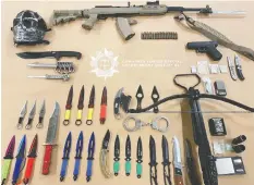  ?? — BC-CFSEU ?? Items seized by police included a loaded semi-automatic rifle, cross bow, knives and drugs.