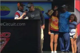  ?? RICHARD PAYERCHIN — THE MORNING JOURNAL ?? Winning team member Brian Zarembski of Avon Lake, second from left, speaks with Jeff Kelm of the Cabela’s Masters Walleye Circuit Team Walleye Tournament, while his teammate Ali Shakoor holds his trophy with his daughters Lianna, 14, and Iman, 9, on...