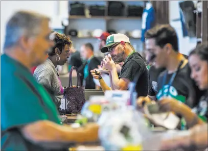  ?? Patrick Connolly ?? Las Vegas Review-journal @Pconnpie Customers check out products at Nuwu Cannabis Marketplac­e near Washington Avenue and Main Street on Friday.