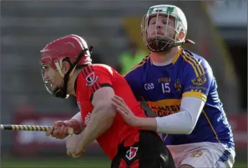  ??  ?? Paul Roche is wrapped up in this tackle by Matthew Maloney of St. Rynagh’s.