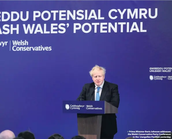  ??  ?? > Prime Minister Boris Johnson addresses the Welsh Conservati­ve Party Conference in the Llangollen Pavilion yesterday