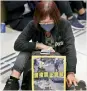  ?? — AP ?? A woman stages a sit-in at a Hong Kong mall.