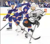  ?? Mary Altaffer Associated Press ?? MATT ROY of the Kings skates away from Sebastian Aho (25) and Hudson Fasching of the Islanders.