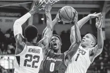  ?? Brandon Wade / Associated Press ?? TCU’s RJ Nembhard, left, and Desmond Bane converge on Cal State Bakersfiel­d’s Jarkel Joiner in the No. 20 Frogs’ opener.