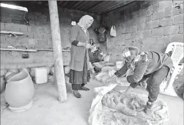  ??  ?? Ayari’s sister kneeds red and white clay before they begin crafting pottery the traditiona­l way, skills which are handed down from generation to generation. — AFP photos