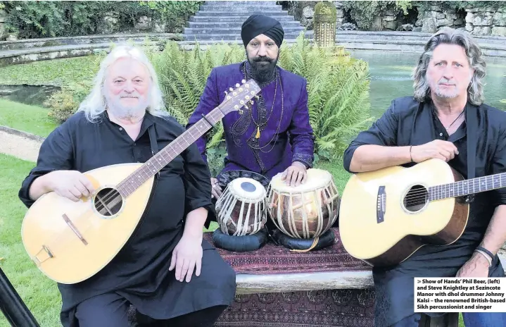  ??  ?? Show of Hands’ Phil Beer, (left) and Steve Knightley at Sezincote Manor with dhol drummer Johnny Kalsi – the renowned British-based Sikh percussion­ist and singer