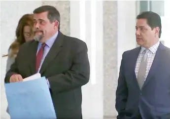  ?? FOX32 ?? Sgt. Xavier Elizondo ( right) enters federal court with his attorneys.