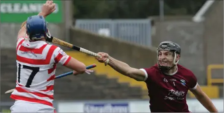  ??  ?? St. Martin’s star man Jack O’Connor misses his intended target as Eoin Murphy of Ferns St. Aidan’s grabs the ball.