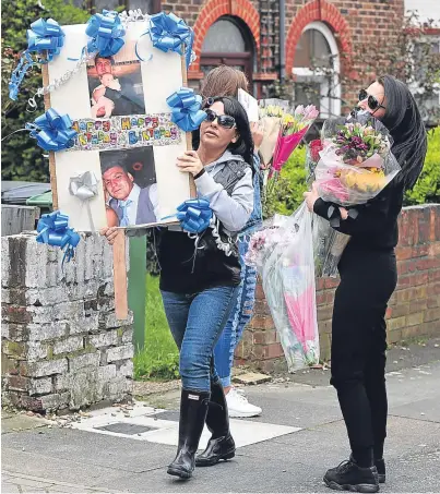  ??  ?? DEATH: Relatives bring tributes to Hither Green, London, where Henry Vincent was stabbed in a botched burglary