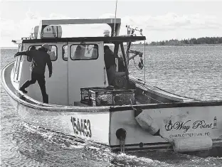  ?? LOGAN MACLEAN • THE GUARDIAN ?? The Way Point, one of the moderate livelihood lobster boats in Lennox Island, backs into harbour before refuelling.