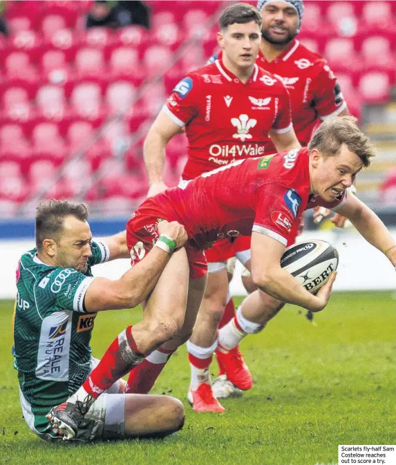  ??  ?? Scarlets fly-half Sam Costelow reaches out to score a try.