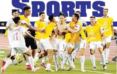  ??  ?? Dennis Chung of the Philippine­s, center, is mobbed by frenzied teammates after scoring a goal against Cambodia during the men’s football match in the 30th Southeast Asian Games Monday at the Rizal Memorial Stadium. The match ended tied 1-1. (Mark Balmores)