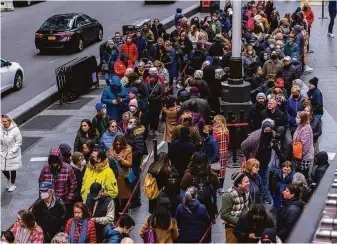  ?? Hiroko Masuike / New York Times ?? People wait to buy Broadway theater tickets in Times Square on March 30. The Omicron subvariant BA.2 is causing a rise in infections in New York City and Washington.