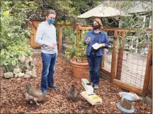  ?? Associated Press ?? Ben Duddleston discusses buying chickens and supplies from Leslie Citroen, owner of Mill Valley Chickens in Mill Valley, Calif., on Dec. 15.