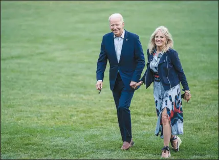  ?? SARAH SILBIGER / THE NEW YORK TIMES ?? President Joe Biden and first lady Jill Biden walk along the South Lawn of the White House on July 18. As the president tries to prove that bipartisan­ship is still possible, the first lady is not standing on the sidelines. She’s visited more than 32 states since her husband’s inaugurati­on.