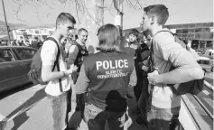  ?? — AFP photo ?? A policewoma­n talks with pupils near the Tocquevill­e high school in the southern French town of Grasse following a shooting that left eight people injured.