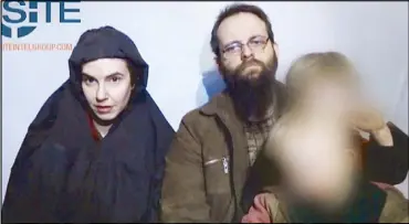  ?? AFP ?? This undated still image from the video provided by the Site Intelligen­ce Group and released on Thursday shows hostage Caitlan Coleman (left) of the United States and her husband Joshua Boyle of Canada speaking while holding their children in an...