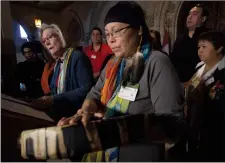  ?? CP PHOTO ADRIAN WYLD ?? Chief Marcia Brown Martel touches her drum as Crown-Indigenous Relations and Rorthern Affairs Minister Carolyn Bennett responds to a question during a news conference on Parliament Hill, in Ottawa on Friday, October 6, 2017. Bennett announced a...