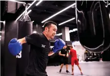  ?? — AFP photo ?? Zhang hitting a punching bag at a boxing gym in Beijing.