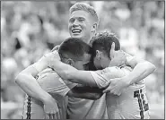  ?? AP/PETR DAVID JOSEK ?? Kevin De Bruyne (center) and Dries Mertens (right) celebrate with Eden Hazard after Hazard scored Belgium’s second goal Saturday.