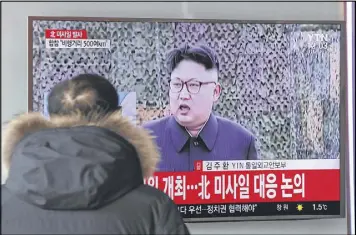  ?? LEE JIN-MAN / ASSOCIATED PRESS ?? A man at the Seoul Train Station in Seoul, South Korea, watches a TV news program Sunday showing a file footage of North Korean leader Kim Jong Un with letters reading: “The North fired a missile.”