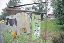  ??  ?? Pierre Jobin, owner of La Ferme du Haut Vallon, is part of a movement of local growers working together under the banner Le Gout de Frelighsbu­rg. left: The sign at La Ferme du Haut Vallon depicts what’s for sale: garlic, apples and lamb.