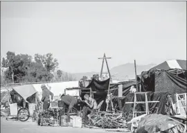  ??  ?? A PROPOSED lawsuit settlement would provide healthcare outreach to homeless people and consistent standards of care at shelters. Above, a riverbed camp.