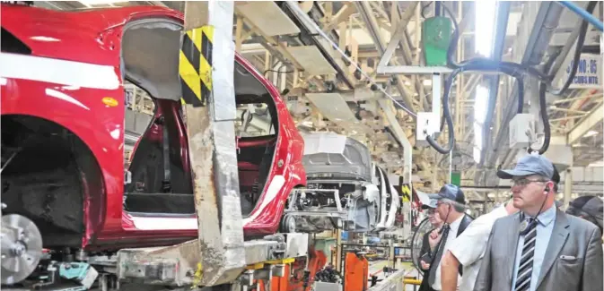  ??  ?? CHENNAI: French Minister of State for Industry, Christophe Sirugue (right) views the assembly lines of Datsun Go and Renault Kwid during a visit to the Renault Nissan Automotive India facility in the southern city of Chennai yesterday. — AFP