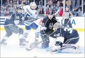  ?? Harry How Getty Images ?? JONATHAN QUICK (32) makes one of his 25 saves for the Kings, and Luke Schenn (52) — who joined the team this week in a trade — lends support.