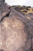  ?? JIM THOMPSON/JOURNAL ?? Images on volcanic rock as seen from a trail at Petroglyph National Monument.