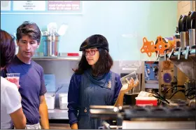  ?? NWA Democrat-Gazette/JASON IVESTER ?? Misa Fontana, 15, fixes bubble tea for a customer Thursday during an open house for Anime Cafe in downtown Rogers.