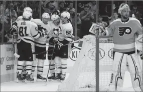  ?? The Associated Press ?? Phil Kessel and his Pittsburgh Penguins linemates celebrate after scoring against Philadelph­ia Flyers goalie Petr Mrazek on Wednesday in Philadelph­ia. Pittsburgh won 5-2.