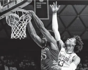  ?? Ray Carlin / Associated Press ?? Kansas center Udoka Azubuike, left, dunks with authority on Baylor forward Freddie Gillespie.