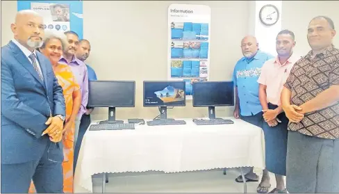  ?? ANZ Fiji country head Saud Minam (left) with school heads and the computers given by ANZ Bank. Picture: SERAFINA SILAITOGA ??