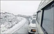  ??  ?? ■
Vehicles stuck in a traffic jam near Rohtang Pass on the Manali-Leh highway after a fresh spell of snow on Sunday. HT PHOTO