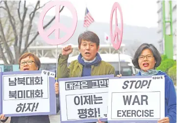  ?? — AFP photo ?? Anti-war activists hold signs during a rally denouncing the annual ‘Foal Eagle’ joint military drill near the US embassy in Seoul.