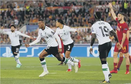  ??  ?? Liverpool celebrate going 2-1 up against Roma with Georginio Wijnaldum’s strike last night.