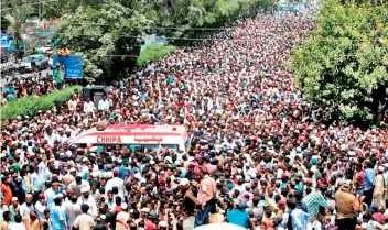  ??  ?? (Above) Thousands of people attend the funeral procession of Amjad Sabri, killed in his car in Karachi, Pakistan. (Left)Bullet holes numbered by police investigat­ors are seen on the windshield of the car driven by Sufi singer Amjad Sabri, who was...